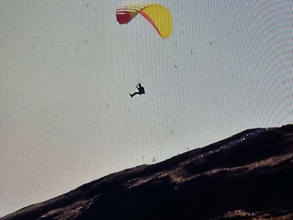 High-altitude aerial expedition in Bolivia with German DAV alpine group and yellow parapente wing in Andean mountain terrain.
