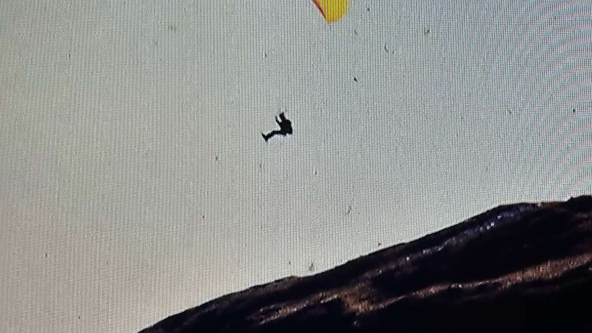 High-altitude aerial expedition in Bolivia with German DAV alpine group and yellow parapente wing in Andean mountain terrain.