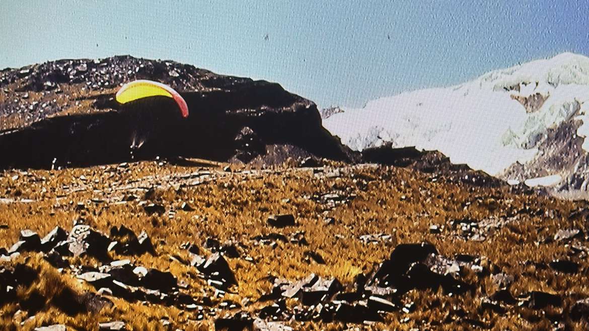 High-altitude aerial expedition in Bolivia with German DAV alpine group and yellow parapente wing in Andean mountain terrain.
