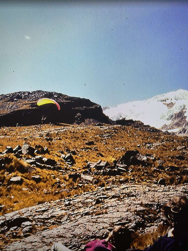 High-altitude aerial expedition in Bolivia with German DAV alpine group and yellow parapente wing in Andean mountain terrain.